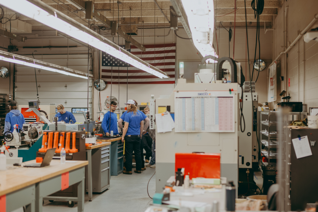 students crowd a cnc demonstration