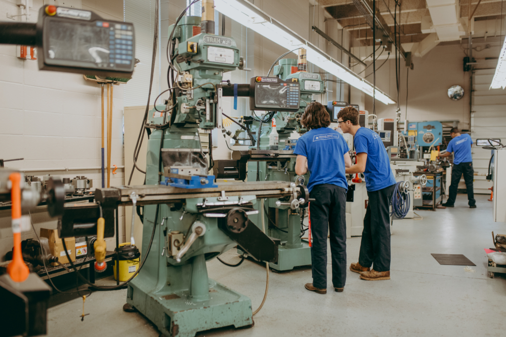 students work on band saw machine