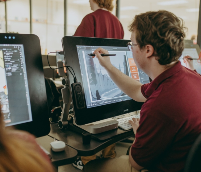 Commercial Art student works on computer design
