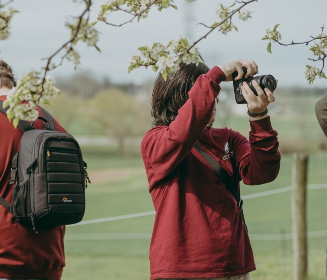 Students taking pictures of tree