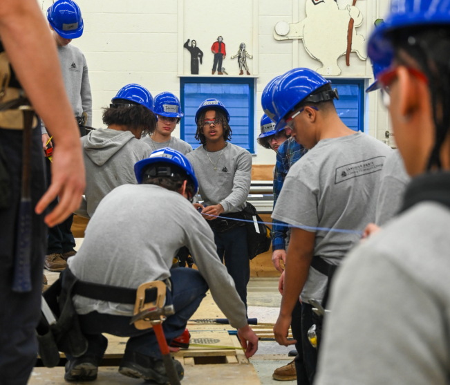 Intro to Construction students measuring wood
