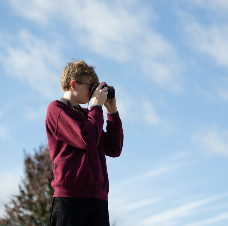 Student photographs cars in staff parking lot