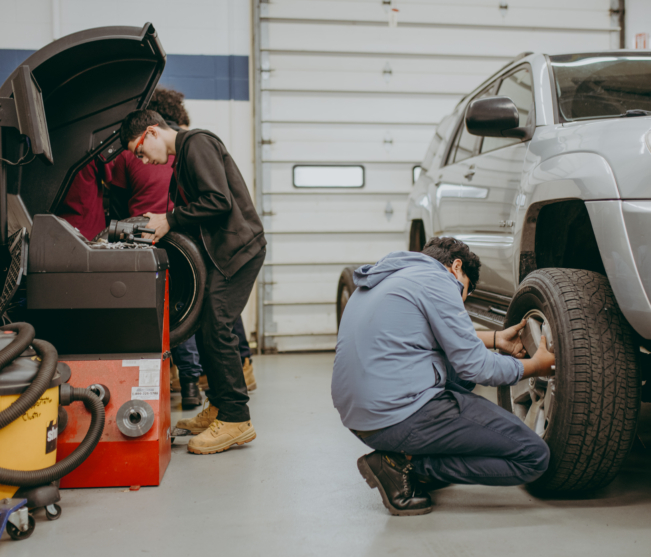 Students working on wheel alignment