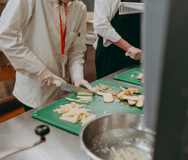 student cuts potatoes