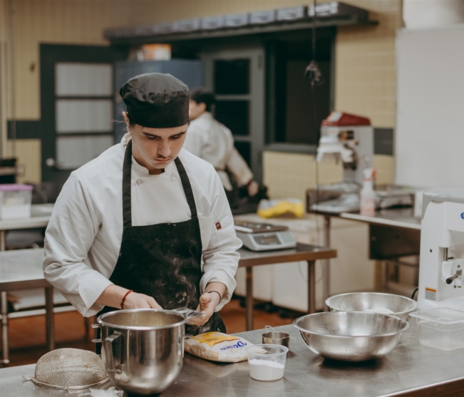 student mixes dry ingredients