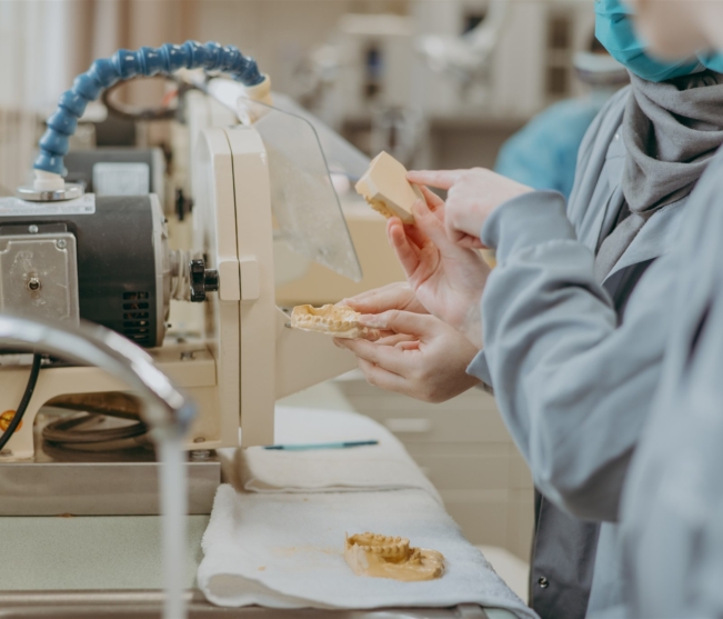 student grinds down dentures
