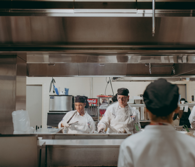students cooking at stovetops