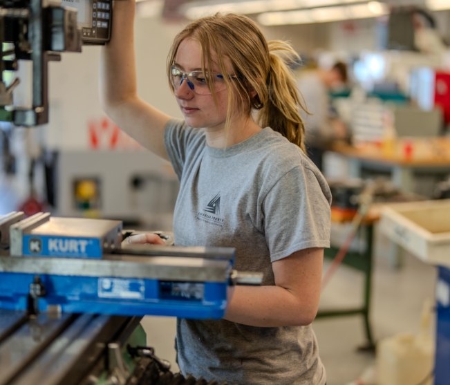 student works on machine