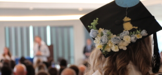 Student wearing Winnie the Pooh grad cap looks on