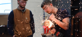 Students grind metal in Diesel Technology shop